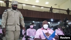 FILE - Paul Rusesabagina, portrayed as a hero in a Hollywood movie about Rwanda's 1994 genocide, sits inside the courtroom in Kigali, Rwanda, Feb. 17, 2021. 