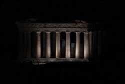 The ancient Parthenon is pictured just before the lights on the Acropolis hill shut down for Earth Hour in Athens, Greece, March 27, 2021.