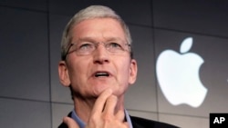 FILE – Apple CEO Tim Cook contends that complying with a government demand to help unlock an iPhone would endanger civil liberties. He’s shown at a 2015 news conference in New York. 