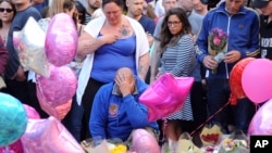  Olivia Campbell's mother, Charlotte Campbell (center) and stepfather, Paul Hodgson (foreground), pay tribute to the victims of the explosion outside Manchester Arena, at St Ann's Square after leading a bikers convoy from their home town of Bury in central Manchester, England, May 25 2017.