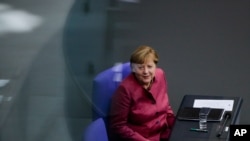 German Chancellor Angela Merkel attends a debate about German government's policies to combat the spread of the coronavirus and COVID-19 disease at the parliament Bundestag, in Berlin, Germany, Oct. 29, 2020.