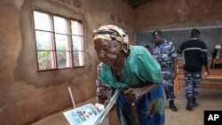 A woman walks to the polling booth to cast her vote in the presidential election, in Giheta, Gitega province, Burundi, May 20, 2020.
