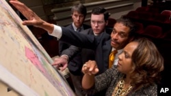 FILE - Lawmakers study a map of the proposed redistricting plan following a meeting of the Legislative Committee on Reapportionment at the Alabama Statehouse in Montgomery, Alabama, May 9, 2012.