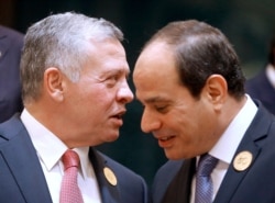 FILE - Egyptian President Abdel-Fattah el-Sissi listens to Jordan's King Abdullah II, left, during a group picture ahead of the Islamic Summit of the Organization of Islamic Cooperation, in Mecca, Saudi Arabia, June 1, 2019.
