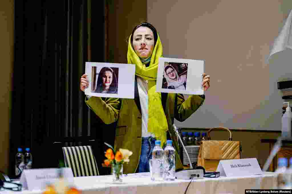 Afghanistan Civil Society Representative Heda Khamoush holds up photos of women's rights activists recently detained in Afghanistan, during a meeting with Afghan Taliban members at the Soria Moria hotel in Oslo, Norway.