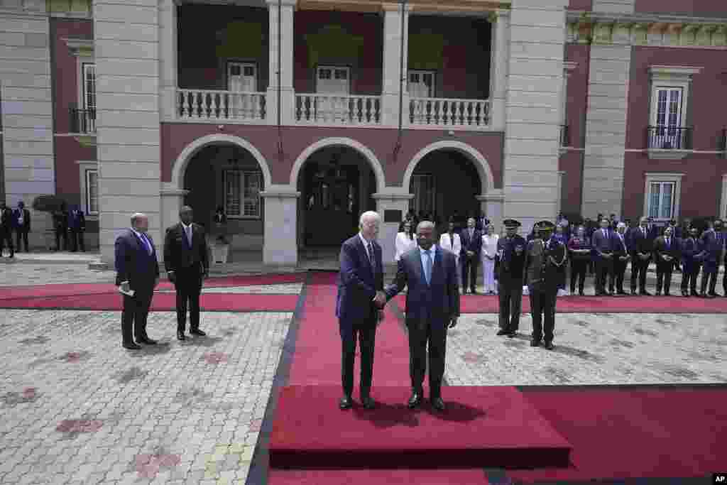 President Joe Biden shakes hand with Angola's President Joao Lourenco, at the presidential palace in the capital Luanda, Angola, during his first trip to Africa as president.