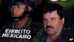 Mexican soldiers and marines escort drug lord Joaquin "El Chapo" Guzman (R) to a waiting helicopter at a federal hangar in Mexico City, Jan. 8, 2016. 