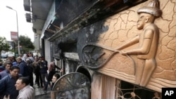 Investigadores egipcios en la escena del ataque incendiario en El Cairo, Egipto.