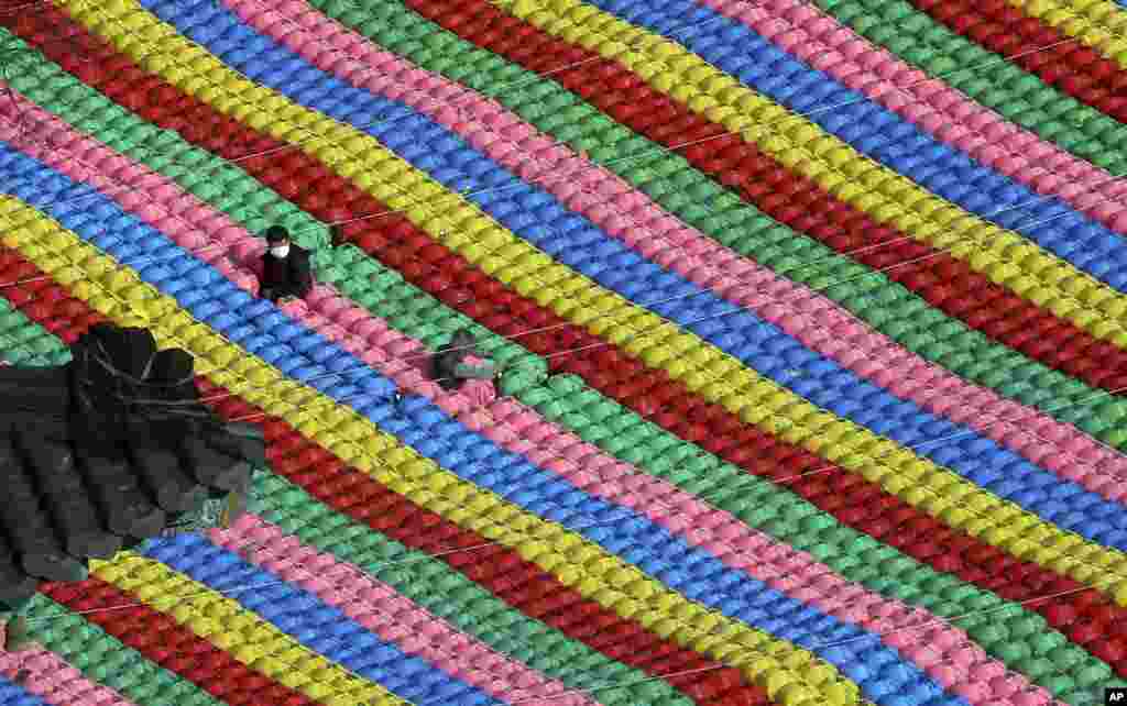Workers adjust lanterns for upcoming celebration of Buddha's birthday on May 22 at Jogye temple in Seoul, South Korea, April 17, 2018.
