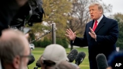 President Donald Trump speaks to members of the media before boarding Marine One on the South Lawn of the White House in Washington, Nov. 26, 2018.